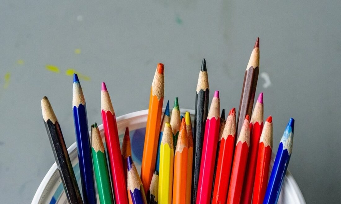 A cup full of sharpened colored pencils, the basic tools of a young artist